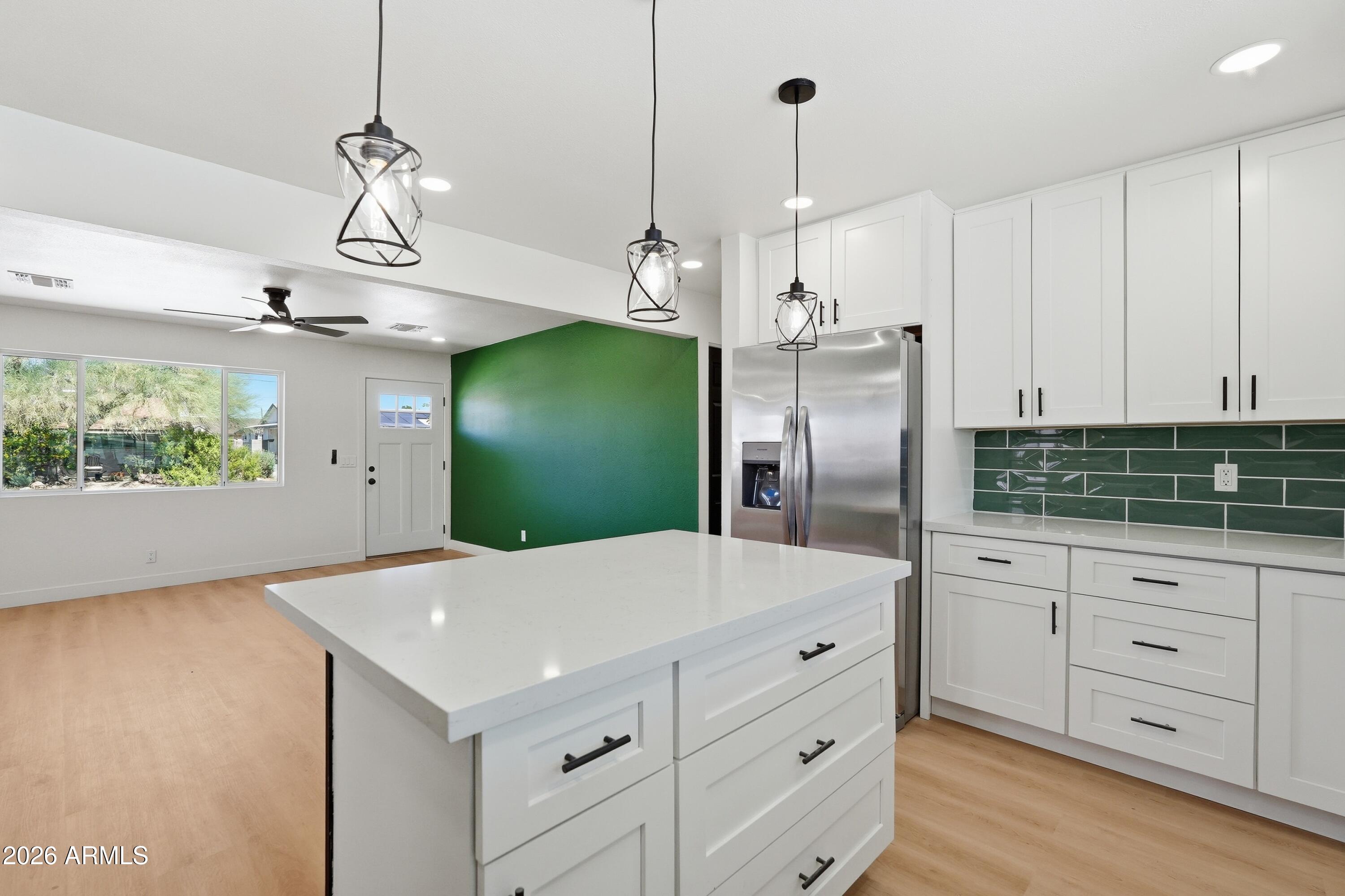 3327 West Wethersfield Road Phoenix, AZ 85029 - Photo 9 of 30 a kitchen with white cabinets and refrigerator