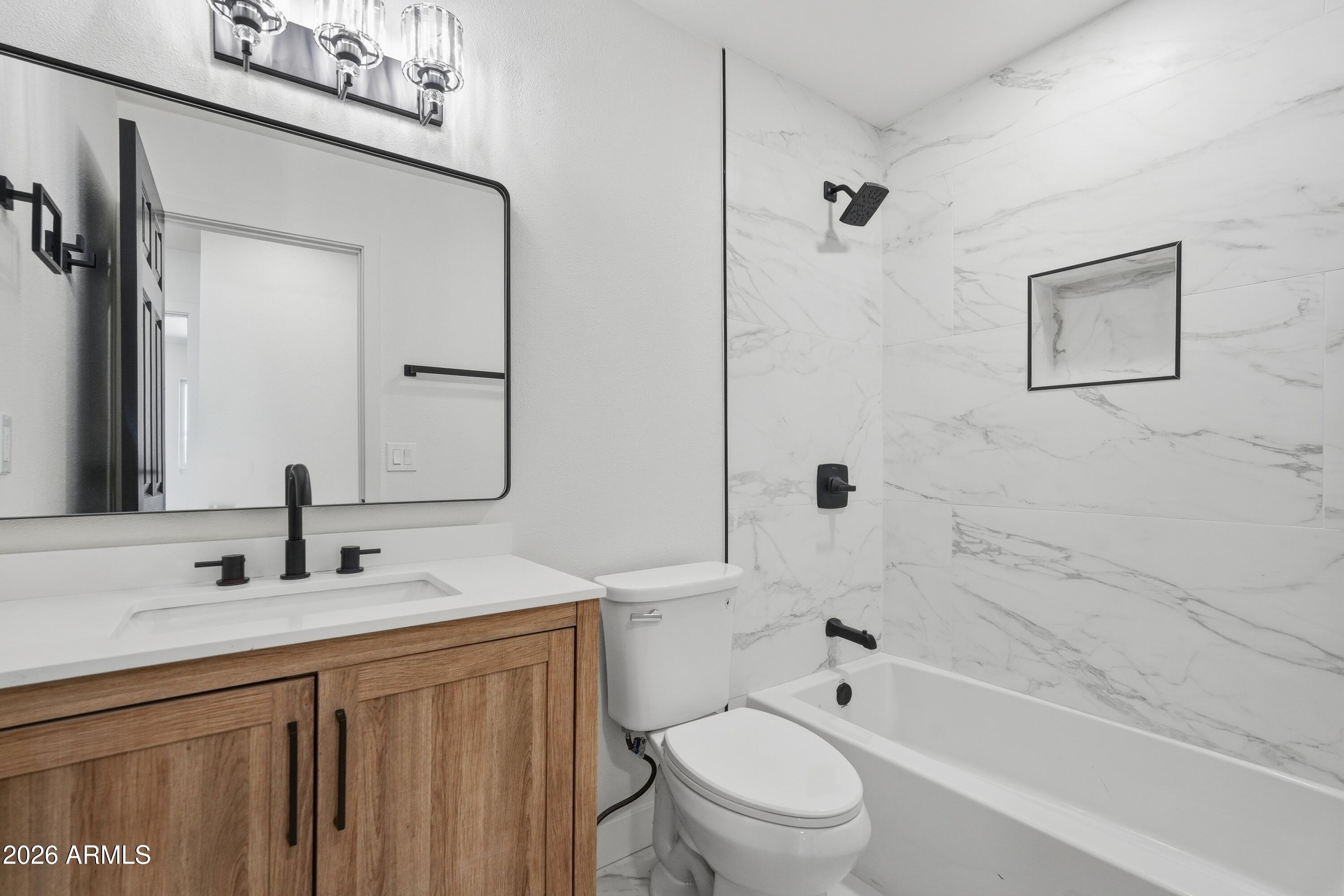 3327 West Wethersfield Road Phoenix, AZ 85029 - Photo 10 of 30 a bathroom with a sink a toilet and shower