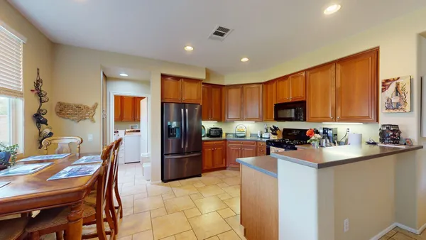 a kitchen with sink a stove and cabinets