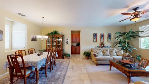 a view of a a dining room with furniture window and wooden floor