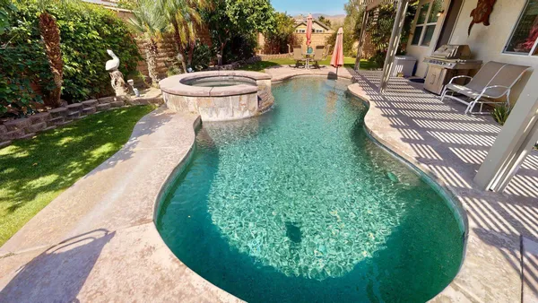 a view of a swimming pool with a patio