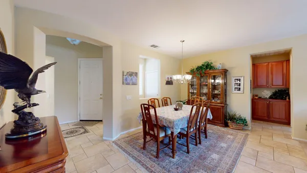 a view of a dining room and livingroom with furniture mirror and wooden floor