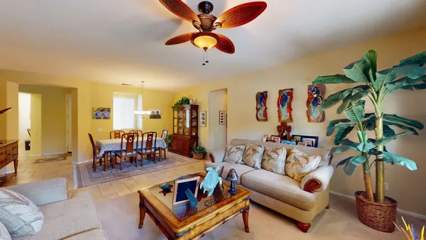 a view of a dining room with furniture and chandelier