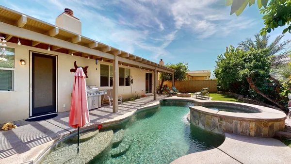 a view of a swimming pool with a yard