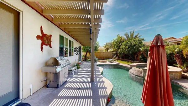 a view of a chair and tables in the backyard