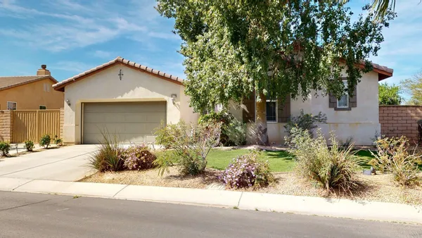 a view of a backyard with plants and patio