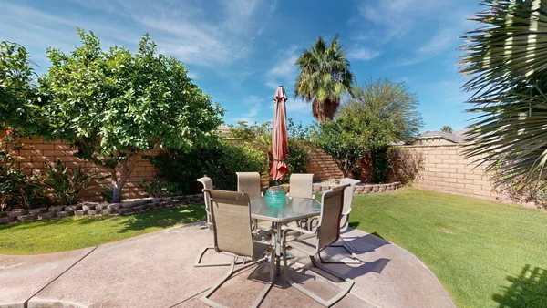 an aerial view of a house with a yard and garden