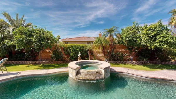 a view of a patio with couches table and chairs and potted plants