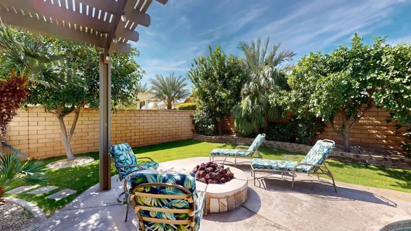 a living room with furniture a ceiling fan and a window