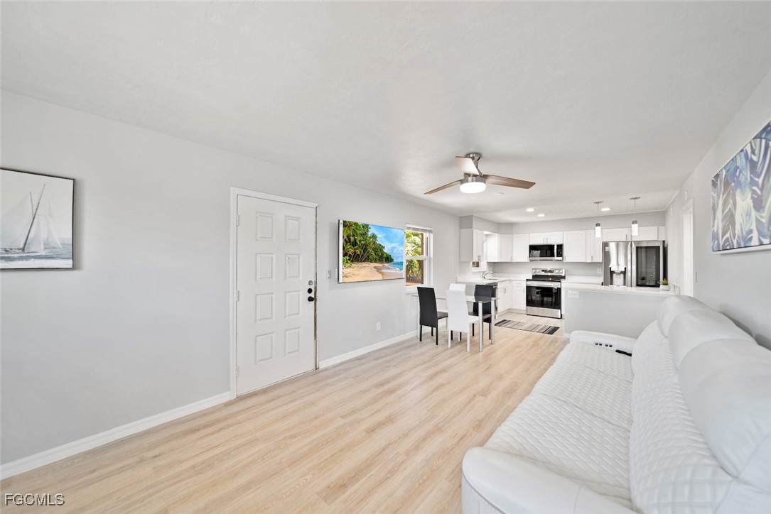 16881 Davis Road, Unit 721 Fort Myers, FL 33908 - Photo 5 of 23 a living room with furniture and a chandelier