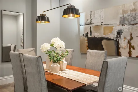 a dining room with furniture and wooden floor