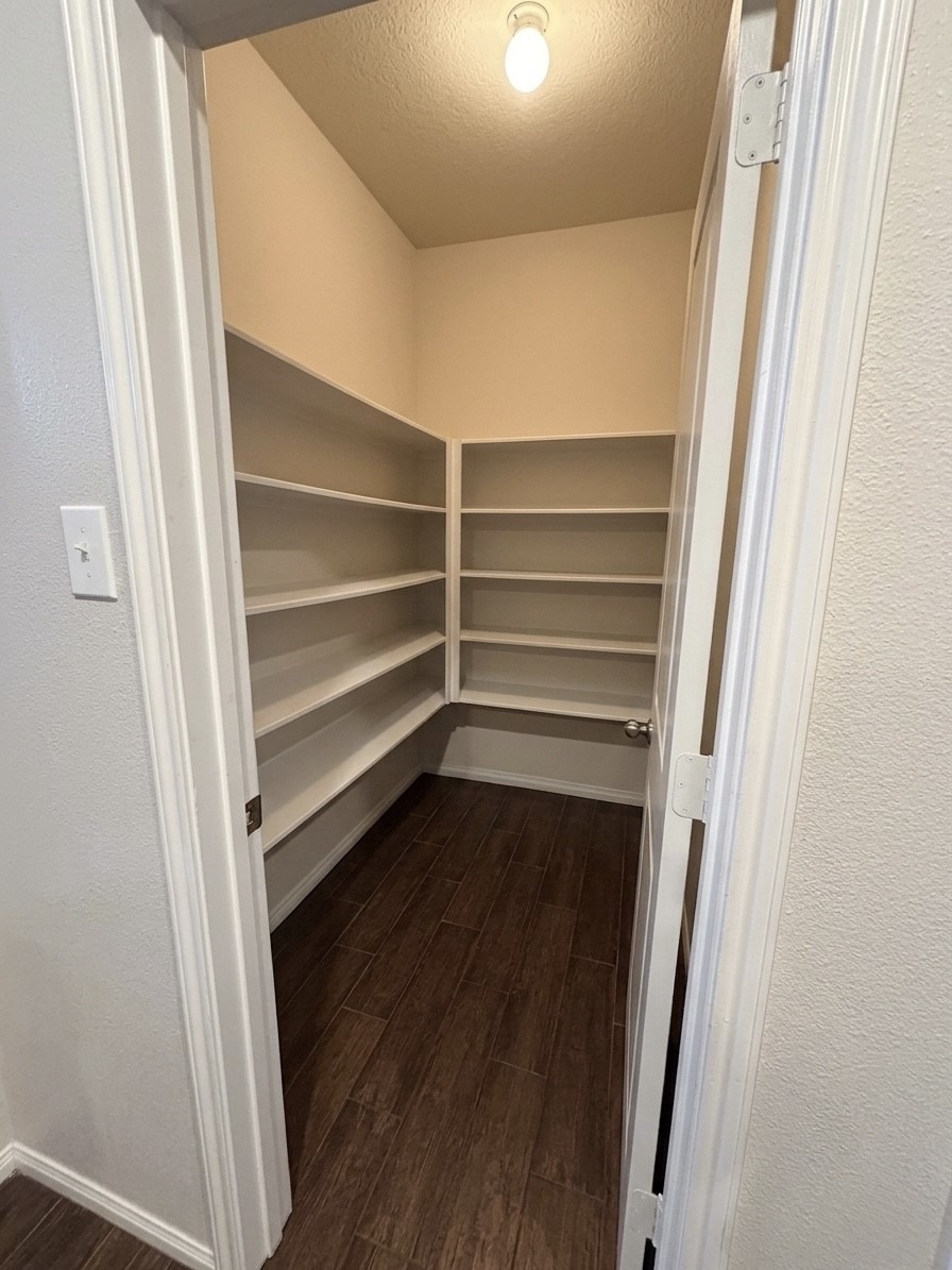9908 Climbing Tree Street Conroe, TX 77385 - Photo 7 of 26 a view of walk in closet with empty racks