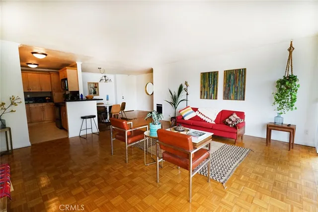 a living room with furniture a dining table and a potted plant