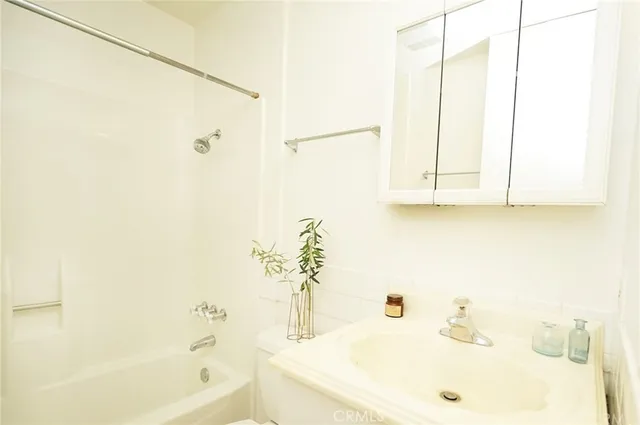 a view of a patio with couches table and chairs and potted plants