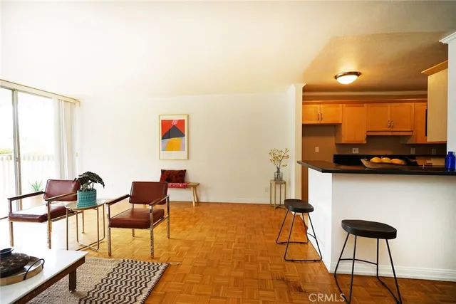 a living room with furniture a rug and a large window