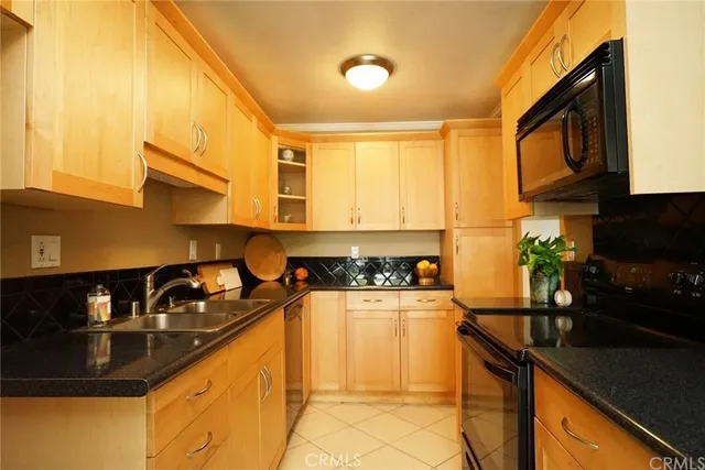 a kitchen with granite countertop a sink and a stove top oven