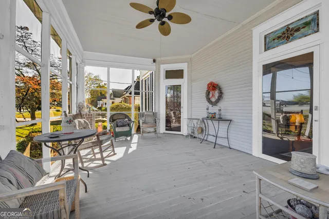 a living room with furniture and large windows