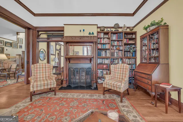 a dining room with furniture a chandelier and wooden floor
