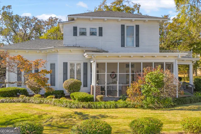a front view of a house with a garden and plants