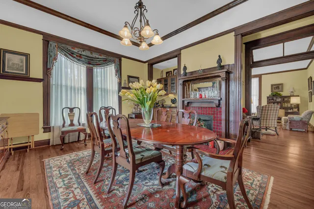 a kitchen with stainless steel appliances granite countertop a stove top oven a sink dishwasher and white cabinets with wooden floor