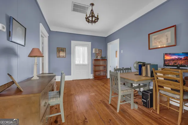 a bedroom with furniture and a chair