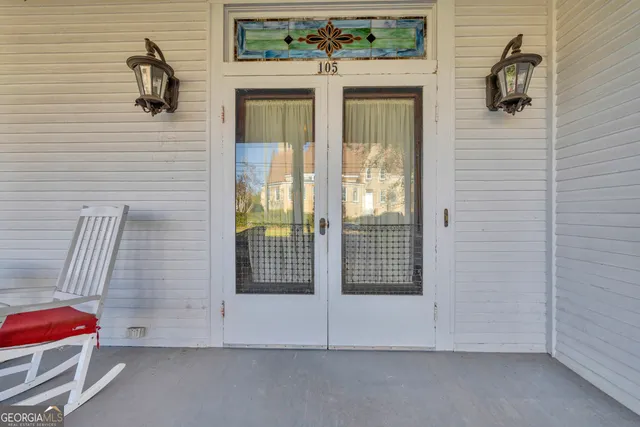 a living room with furniture rug and wooden floor