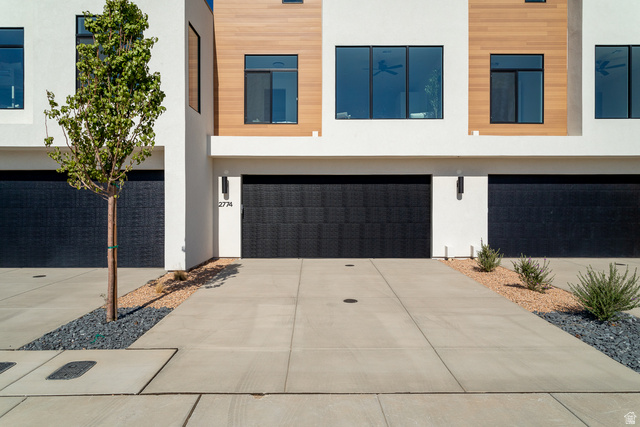 2768 Becco Trail, Unit 63 St. George, UT 84770 - Photo 27 of 27 Modern home with a garage, stucco siding, and driveway