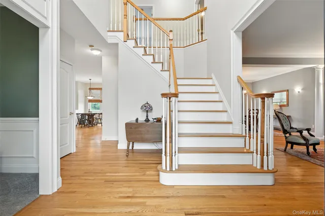 a kitchen with stainless steel appliances a dining table chairs stove refrigerator and cabinets