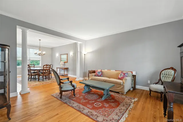a dining room with wooden floor a chandelier and wooden floor
