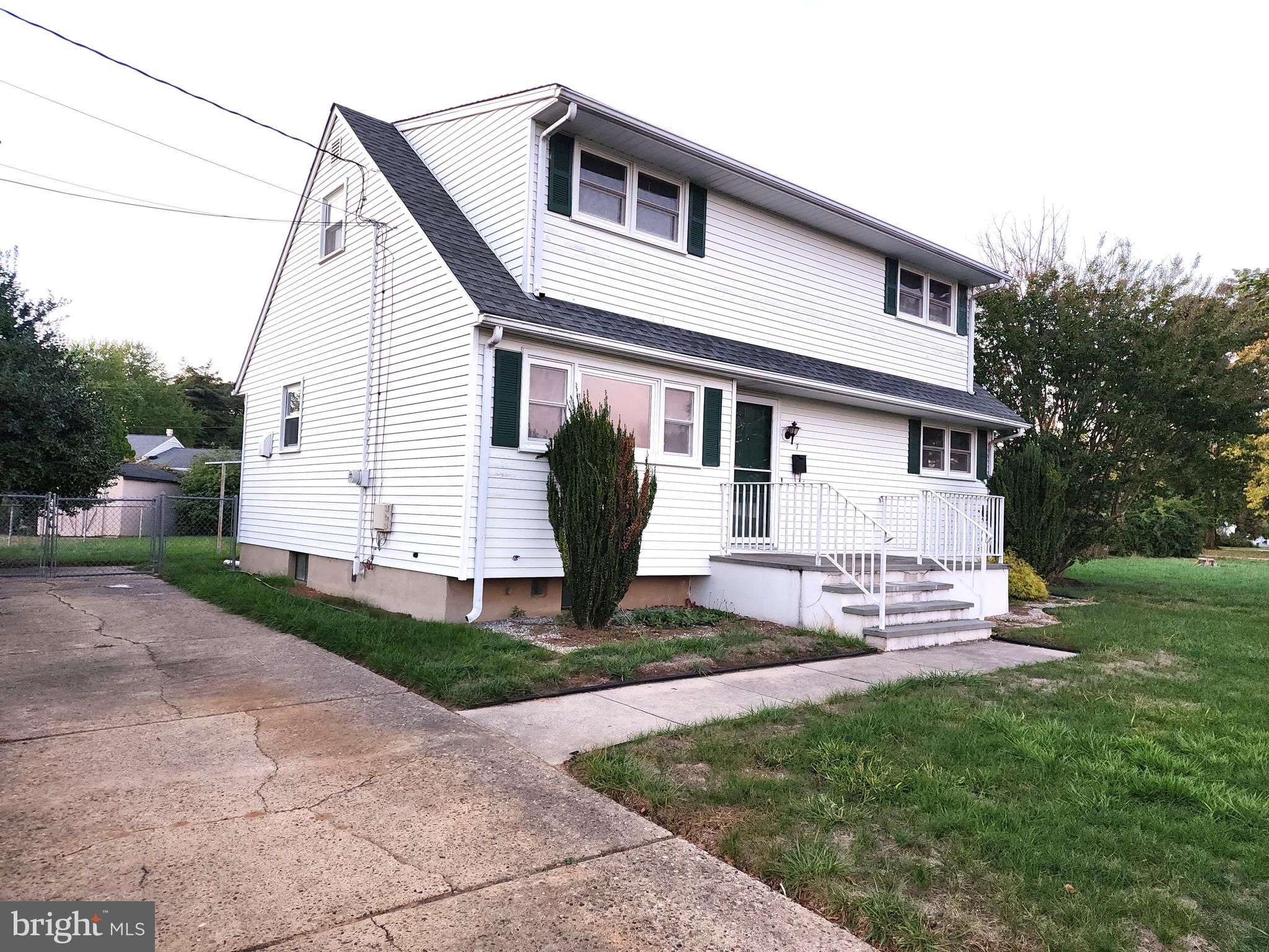 7 Saranac Road Hamilton, NJ 08619 - Photo 3 of 19 a front view of a house with a garden and yard