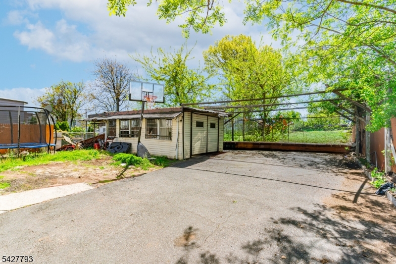 420 Mechanic Street Orange, NJ 07050 - Photo 18 of 18 a front view of a house with a yard and a garage
