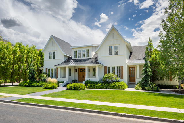 630 East Center Street Alpine, UT 84004 - Photo 5 of 115 Gable-front home featuring white siding, brown wood shutters, a dark shingle roof, and a covered porch with white columns