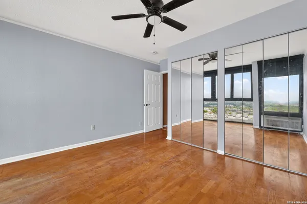 a bedroom with a bed and glass window