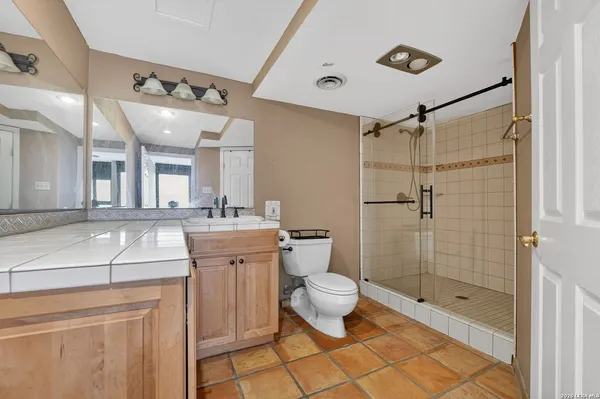 a bathroom with a shower toilet and sink
