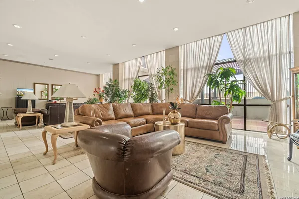 a living room with furniture and a potted plant