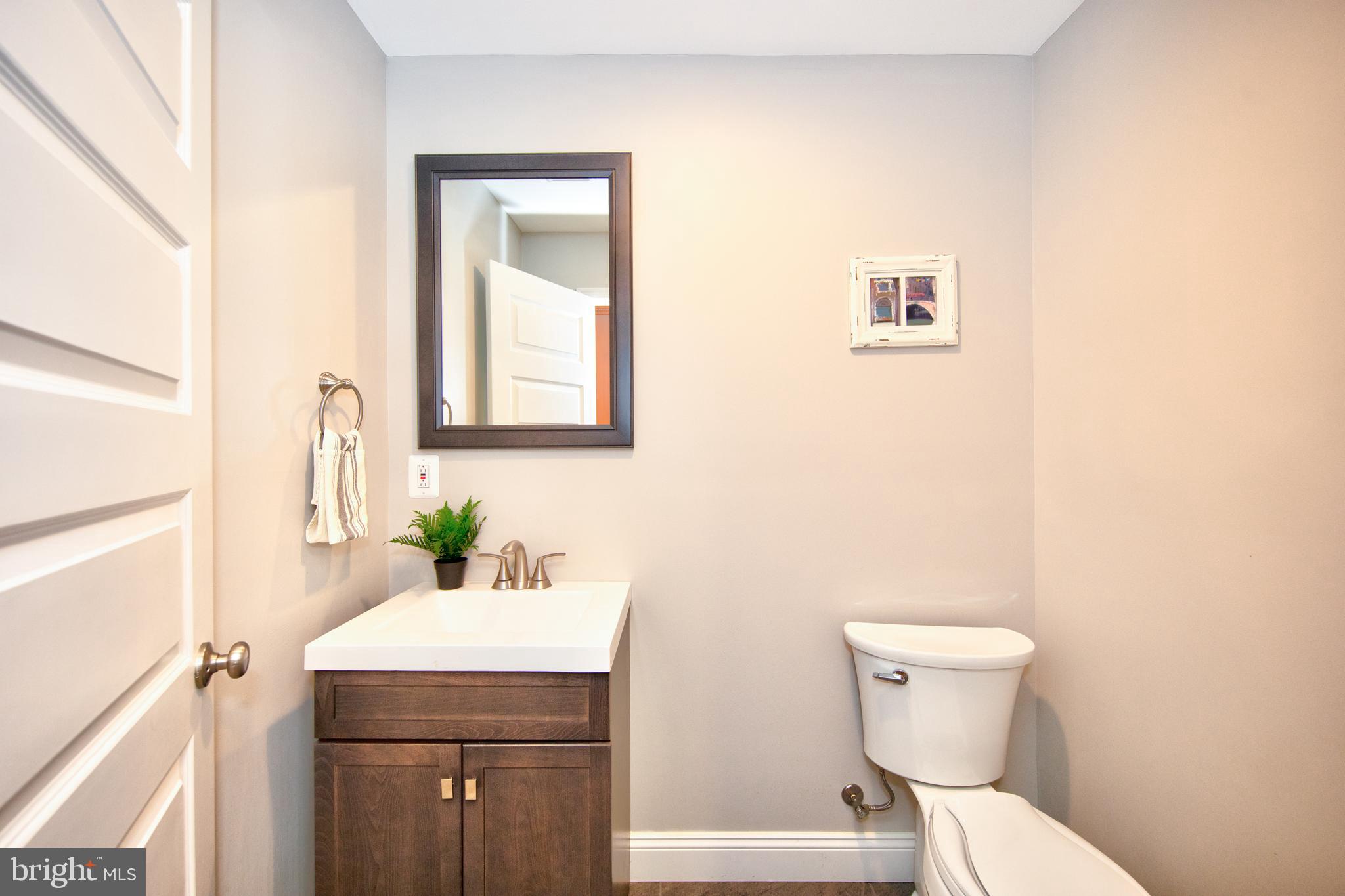 9315 Perglen Road Baltimore, MD 21236 - Photo 11 of 32 a bathroom with a toilet sink and mirror