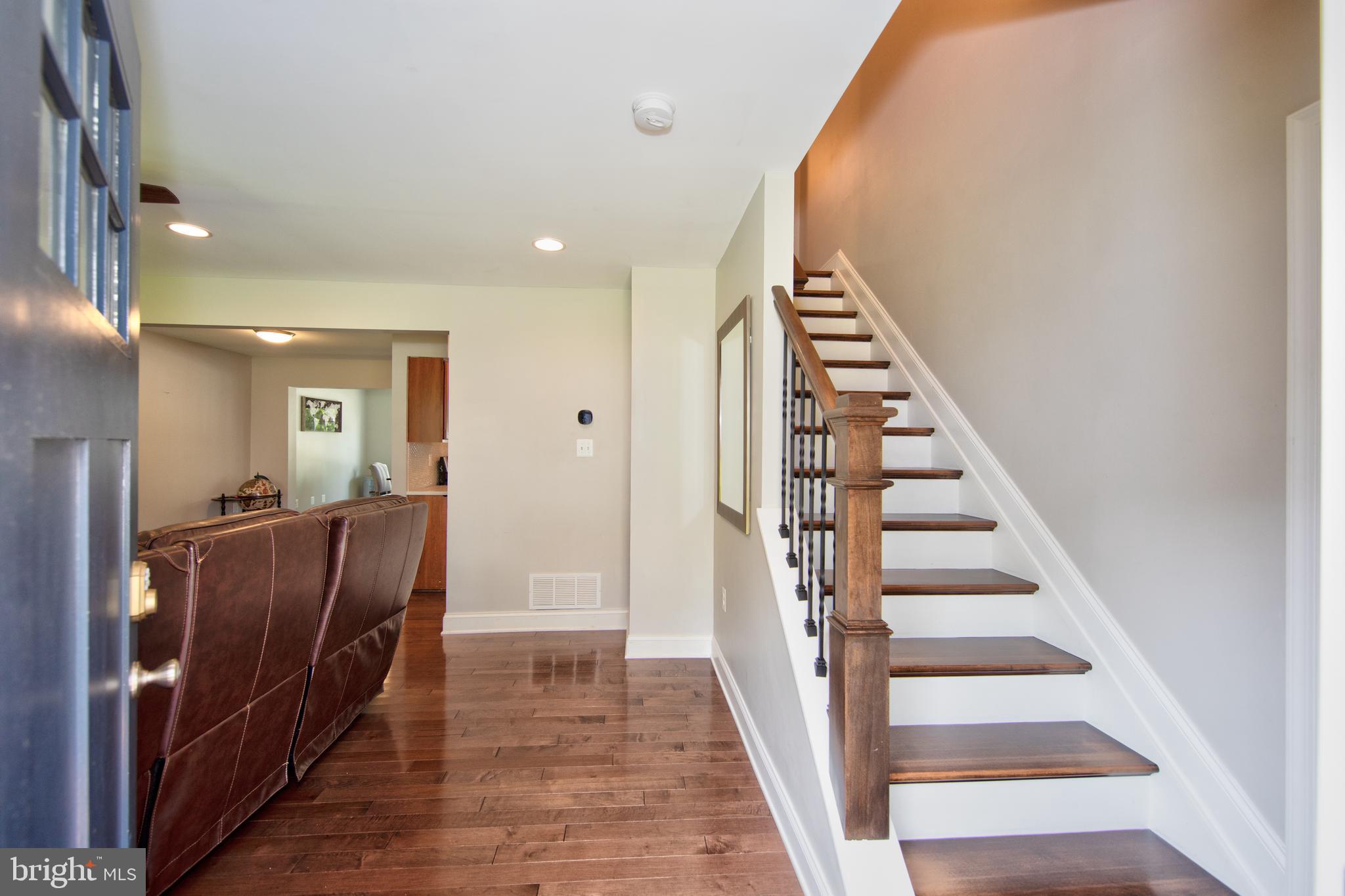 9315 Perglen Road Baltimore, MD 21236 - Photo 12 of 32 a view of a hallway with wooden floor and stairs