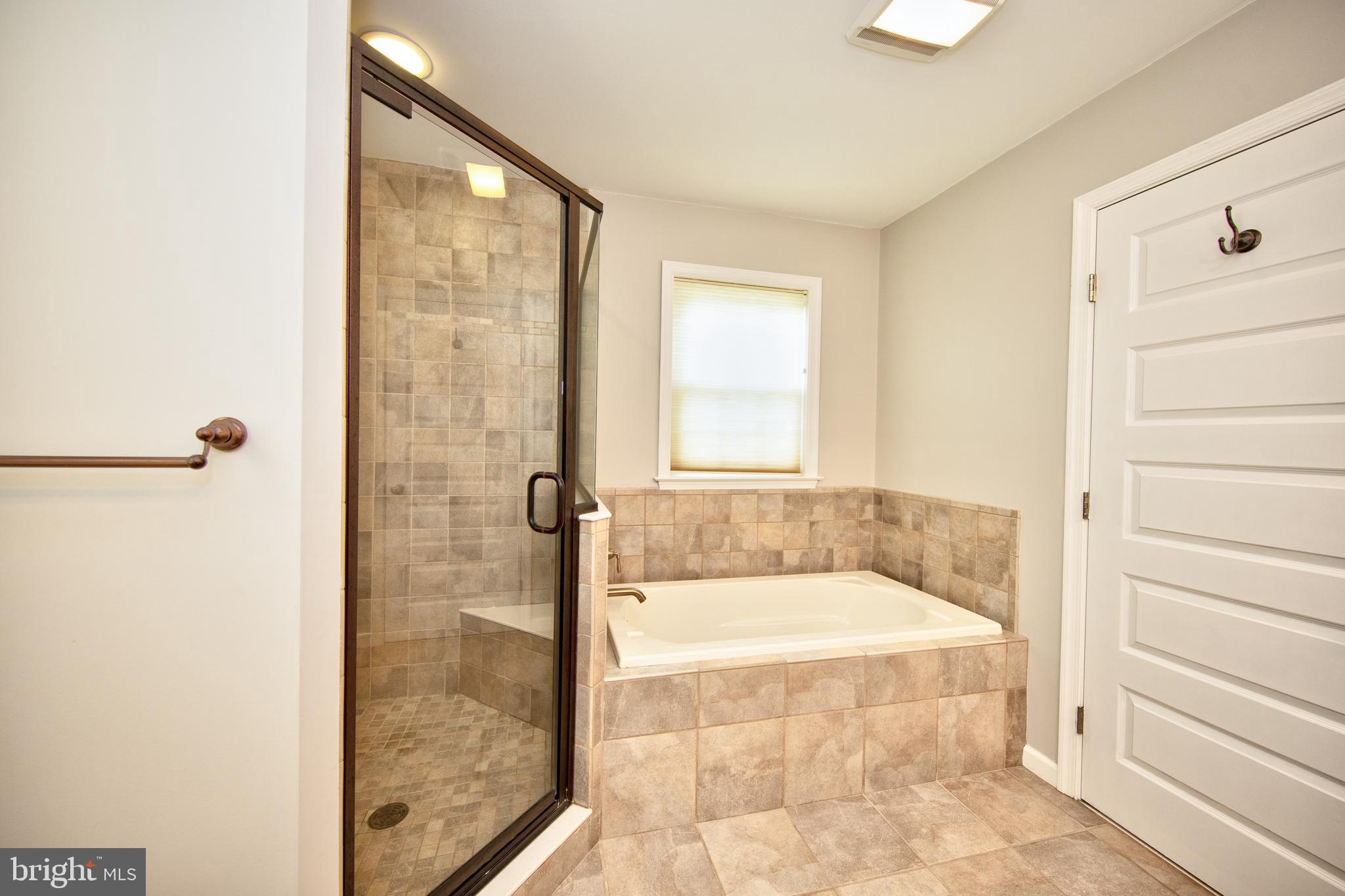 9315 Perglen Road Baltimore, MD 21236 - Photo 15 of 32 a bathroom with a tub and shower