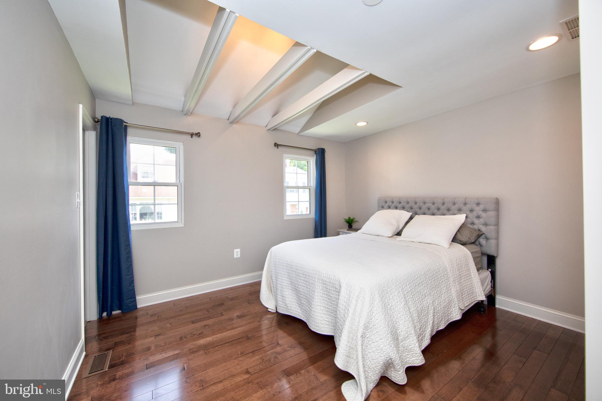 9315 Perglen Road Baltimore, MD 21236 - Photo 16 of 32 a bedroom with a bed and wooden floor