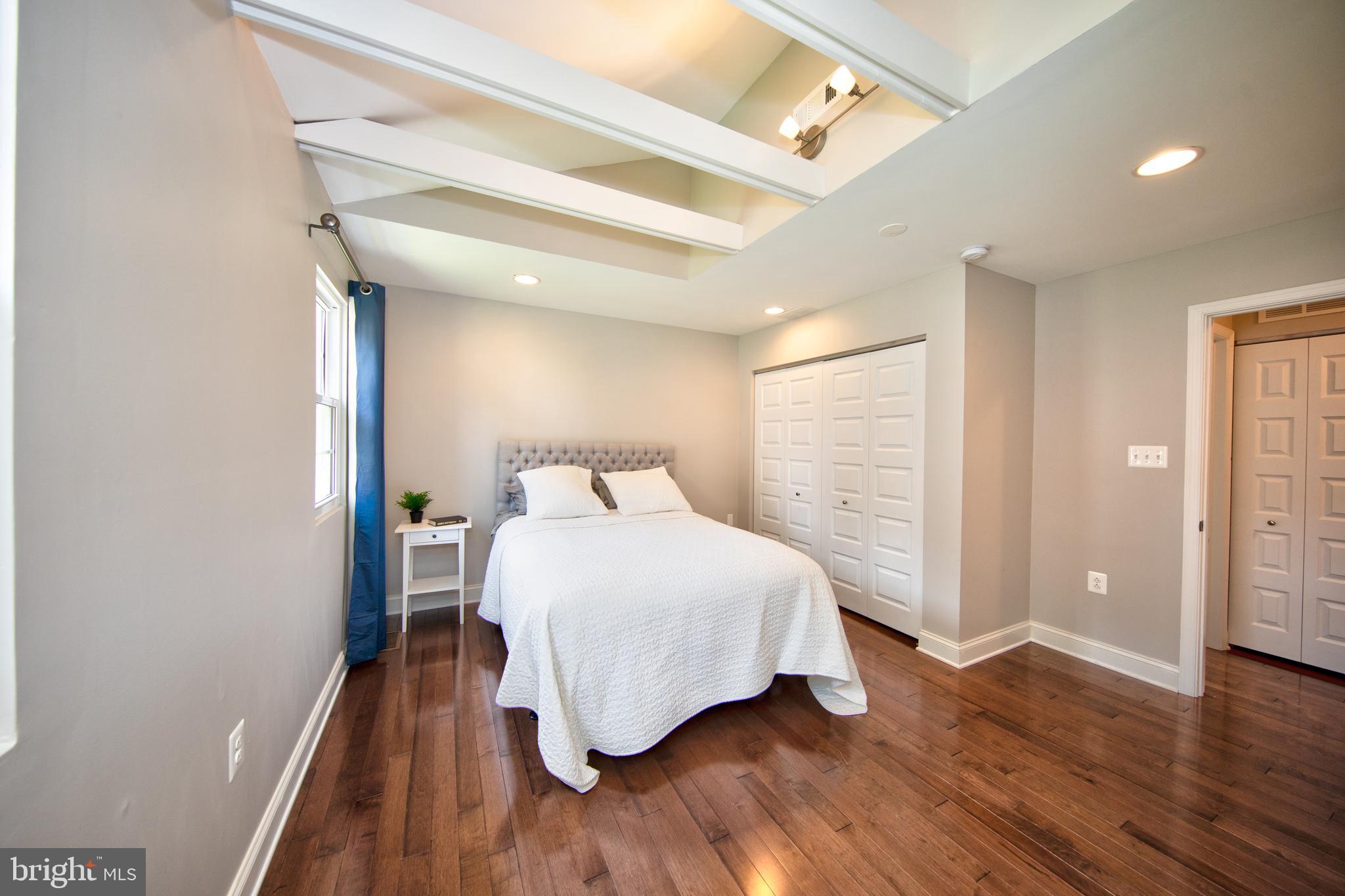 9315 Perglen Road Baltimore, MD 21236 - Photo 17 of 32 a bedroom with a bed and wooden floor