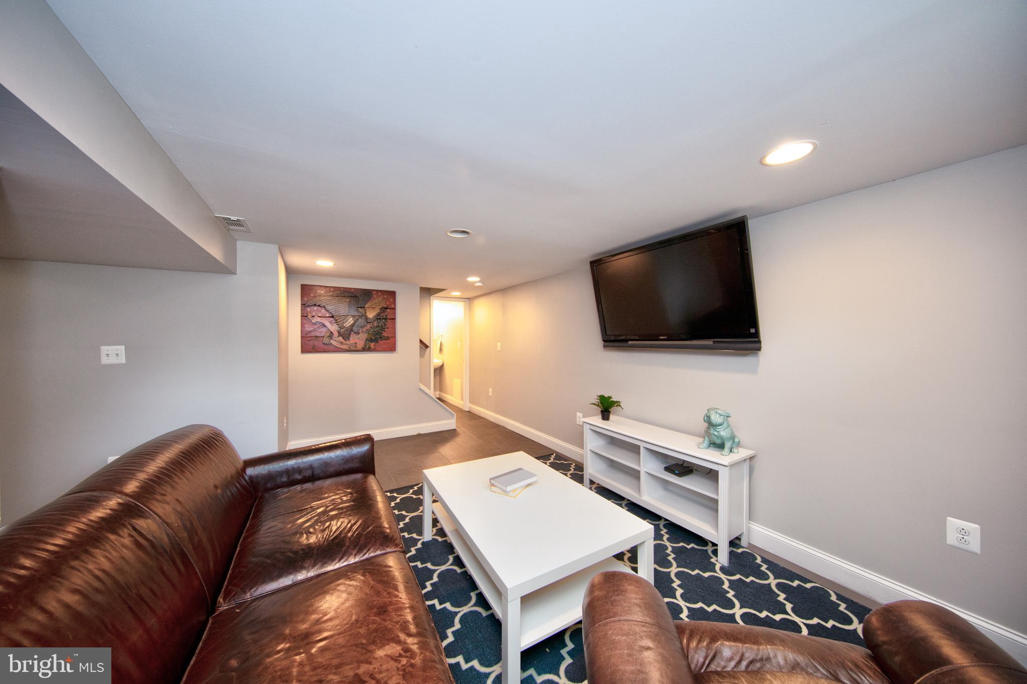 9315 Perglen Road Baltimore, MD 21236 - Photo 23 of 32 a living room with furniture and a flat screen tv