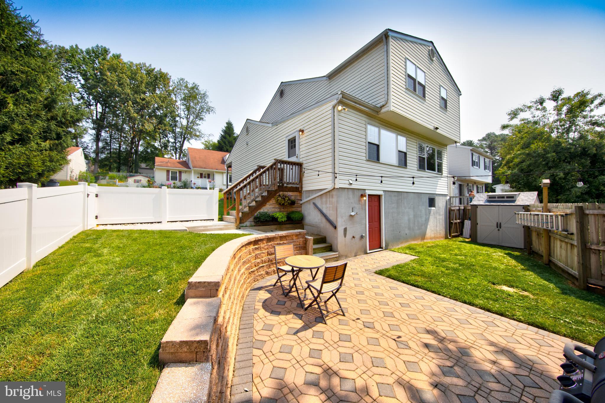 9315 Perglen Road Baltimore, MD 21236 - Photo 29 of 32 a view of a house with a backyard and a garden