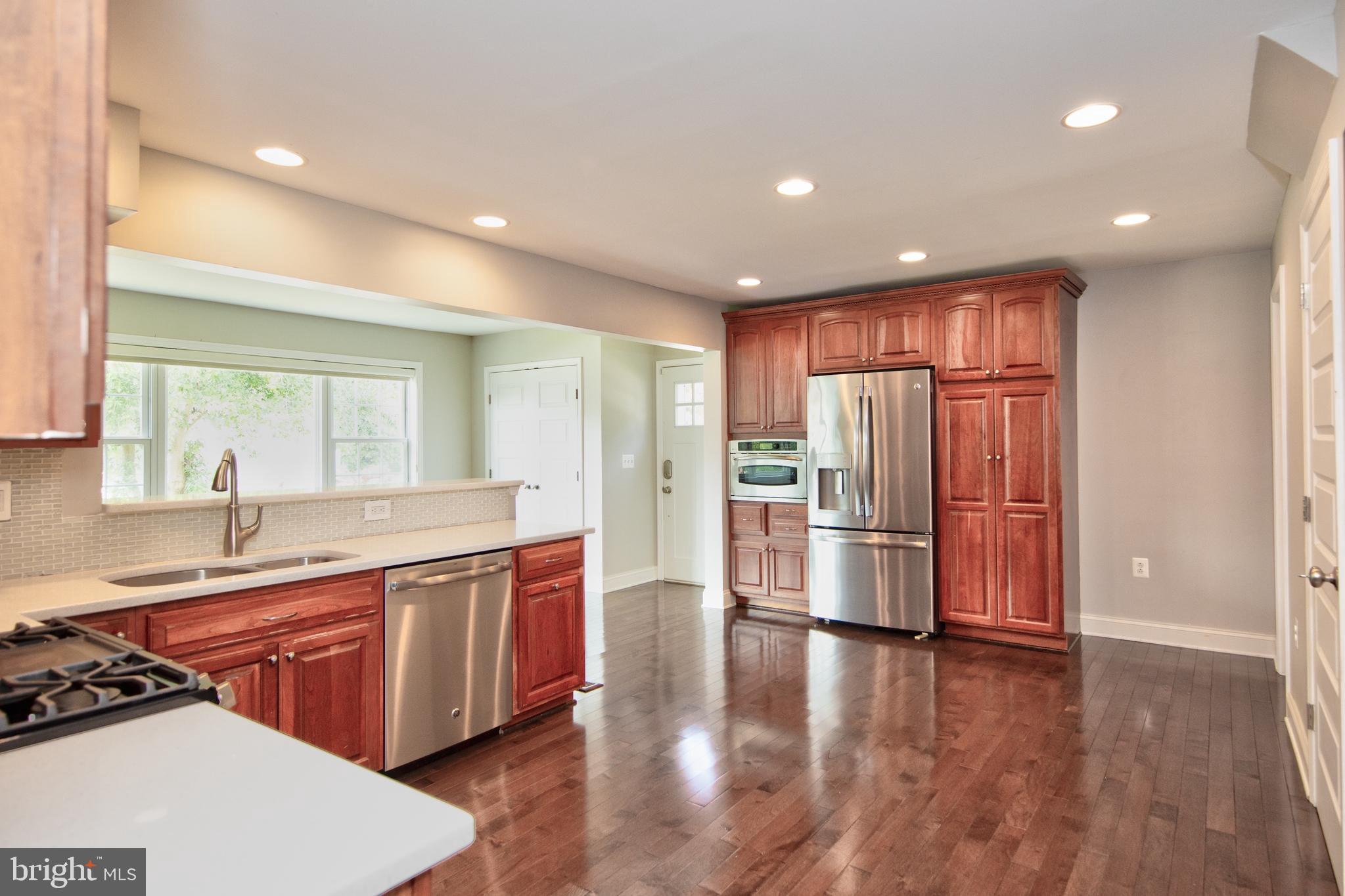 9315 Perglen Road Baltimore, MD 21236 - Photo 3 of 32 a large kitchen with stainless steel appliances granite countertop a lot of counter space and wooden floor