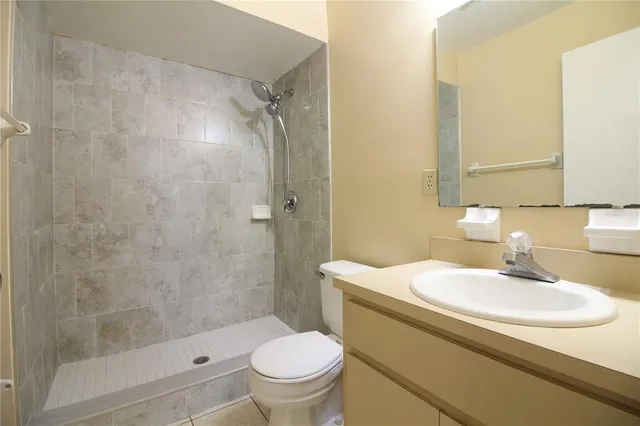 a bathroom with a sink toilet and shower