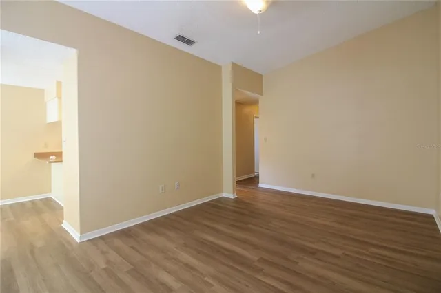 an empty room with wooden floor