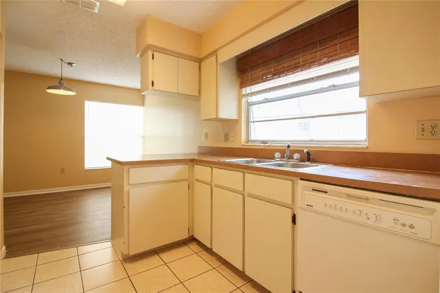 a kitchen with a sink cabinets and window