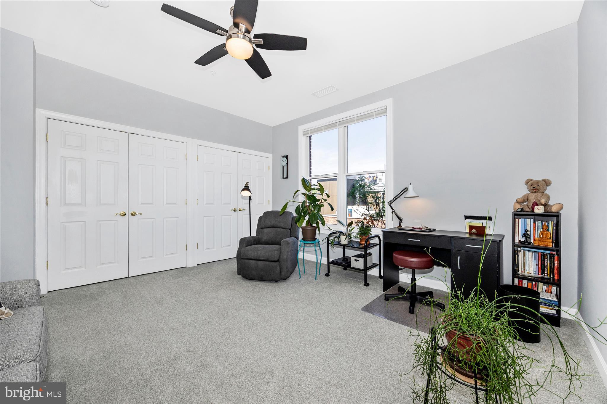 35 East All Saints Street, Unit 211 Frederick, MD 21701 - Photo 13 of 61 a living room with furniture and a potted plant