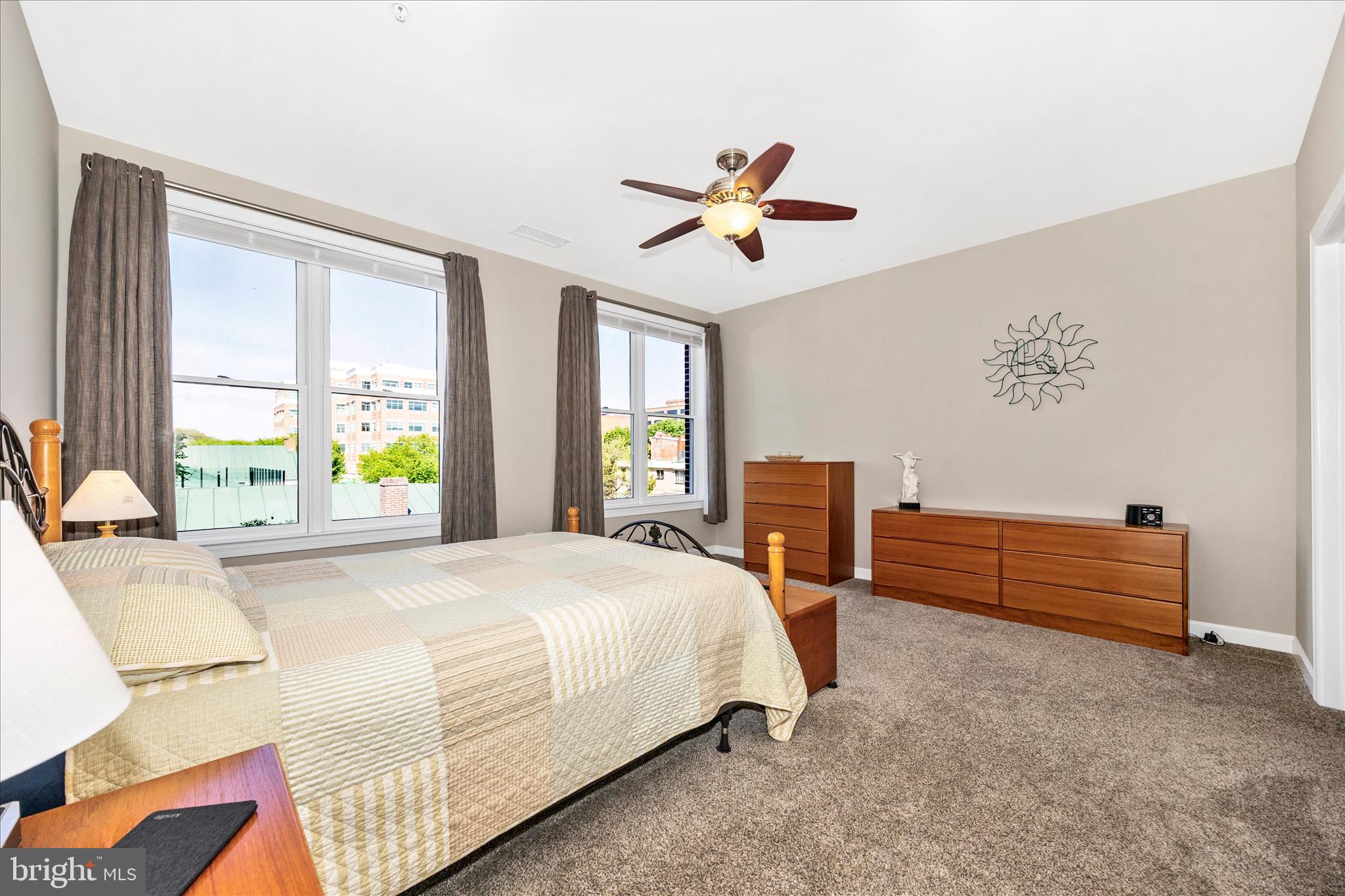 35 East All Saints Street, Unit 211 Frederick, MD 21701 - Photo 20 of 61 a spacious bedroom with a bed and a table