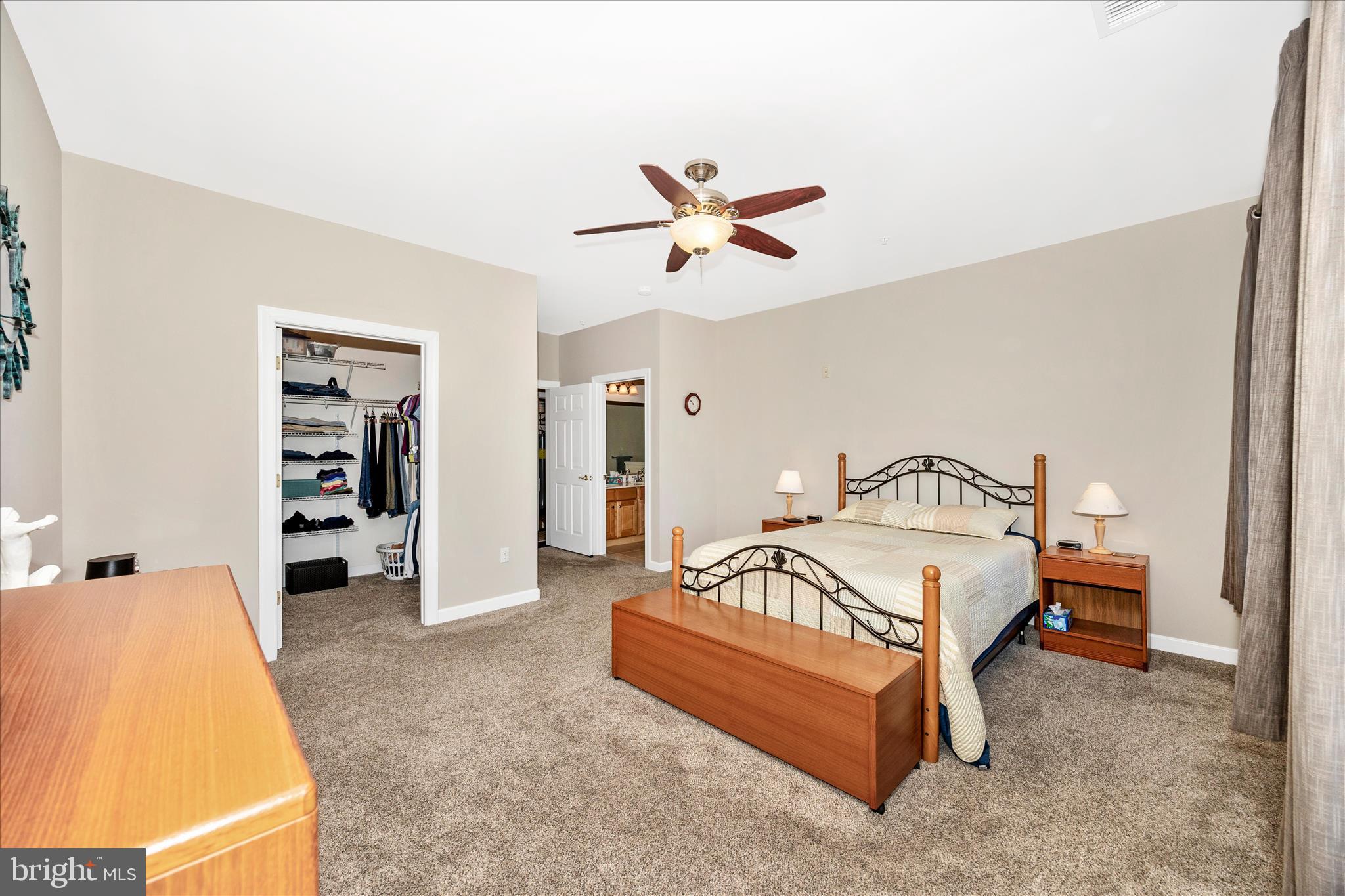 35 East All Saints Street, Unit 211 Frederick, MD 21701 - Photo 22 of 61 a spacious bedroom with a bed and a walk in closet