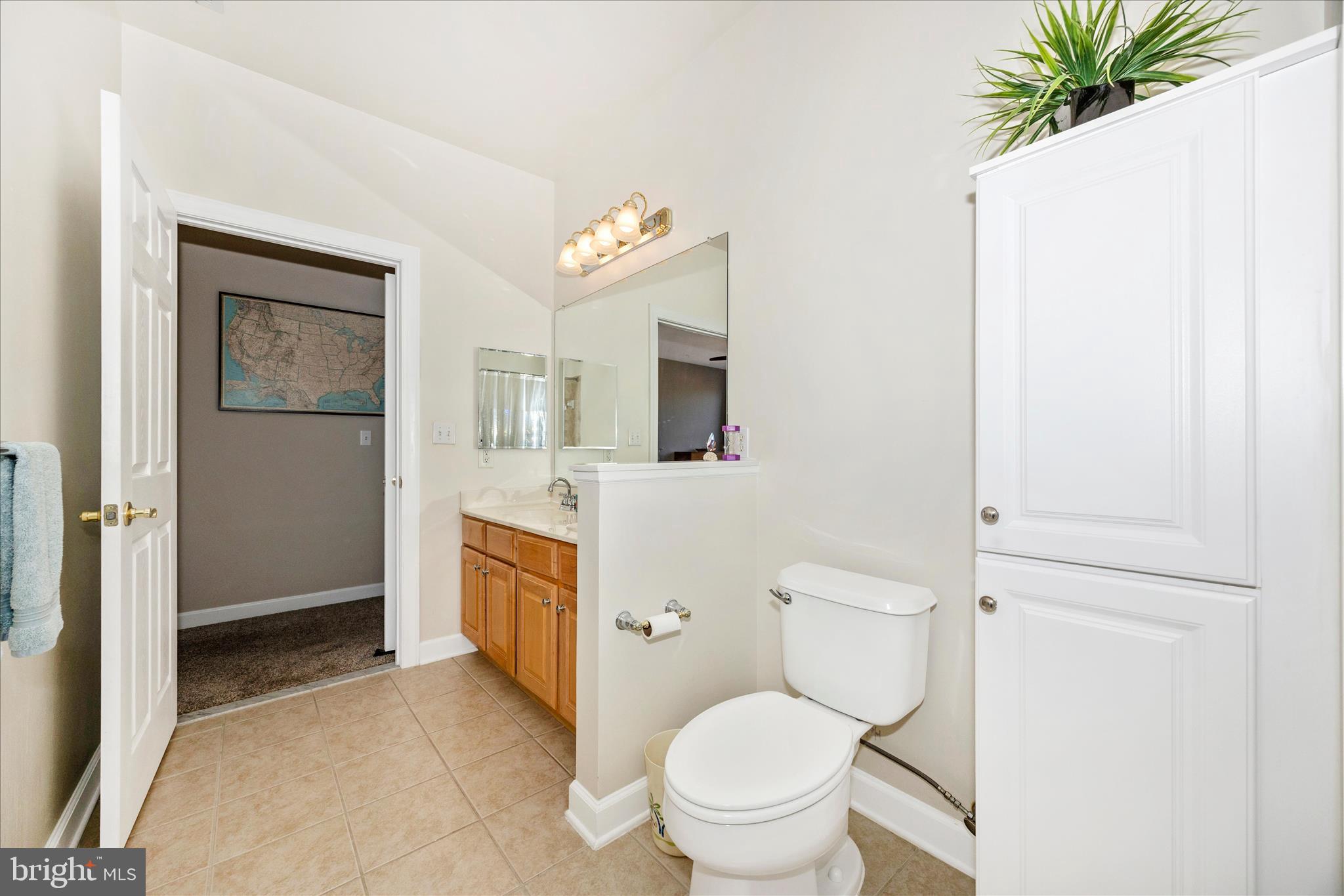 35 East All Saints Street, Unit 211 Frederick, MD 21701 - Photo 25 of 61 a bathroom with a granite countertop toilet sink and mirror